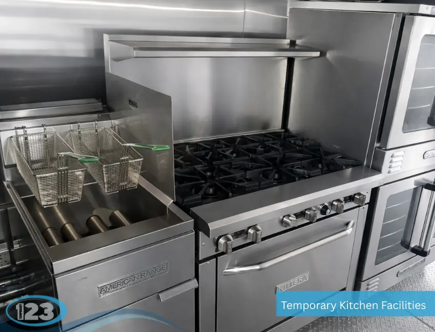 Mobile kitchen trailer with commercial gas range, deep fryer with baskets, oven, and stainless steel cooking surfaces