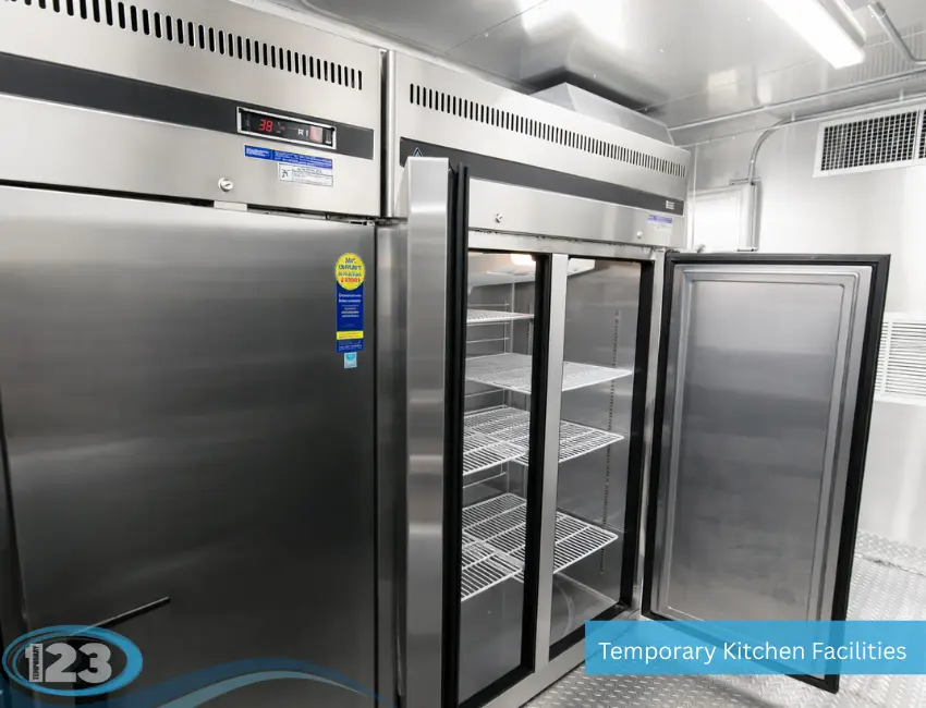 Commercial refrigerator and freezer inside mobile kitchen trailer with stainless steel finish and glass display doors