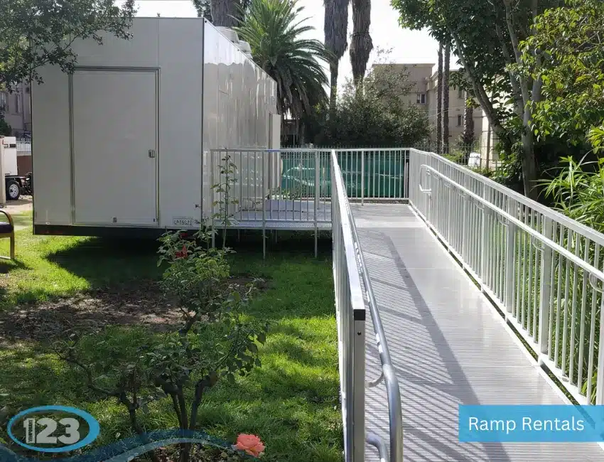 Mobile kitchen trailer exterior with accessibility ramp and platform setup for easy entry at outdoor location