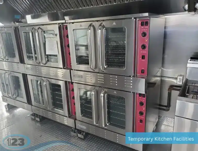 Commercial convection ovens inside mobile kitchen trailer with stainless steel finish and stacked cooking units